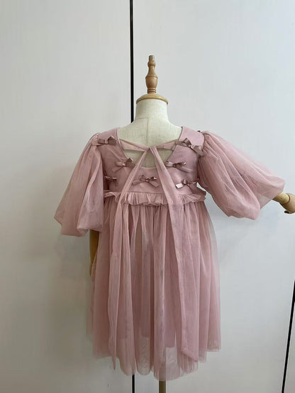 Vestido infantil rosa con lazos 
