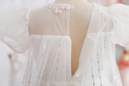 White children's dress with glitter.
