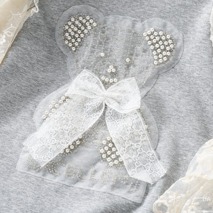 Vestido infantil con oso y encaje. 