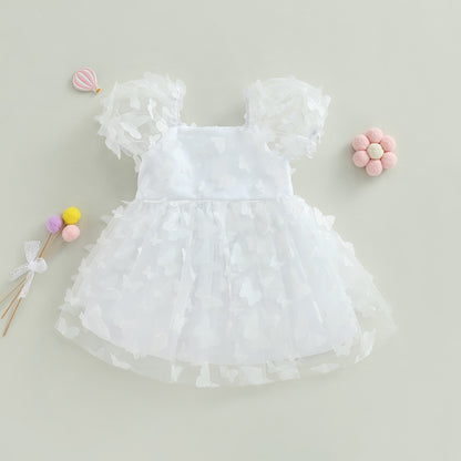Vestido infantil de tul azul con flores de colores.