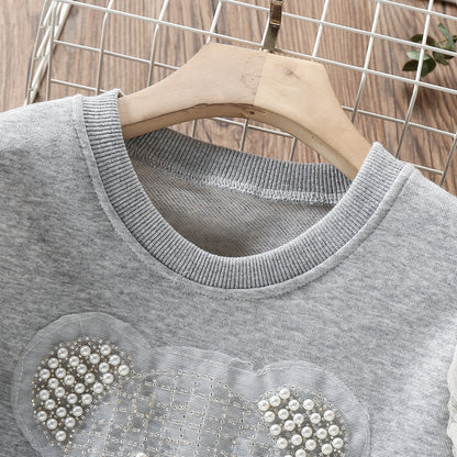 Vestido infantil con oso y encaje. 