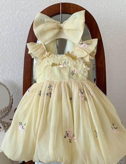 Vestido infantil amarillo con lazo de flores pequeñas 